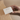 Hand holding a €40 Petite Mort gift card against a neutral background